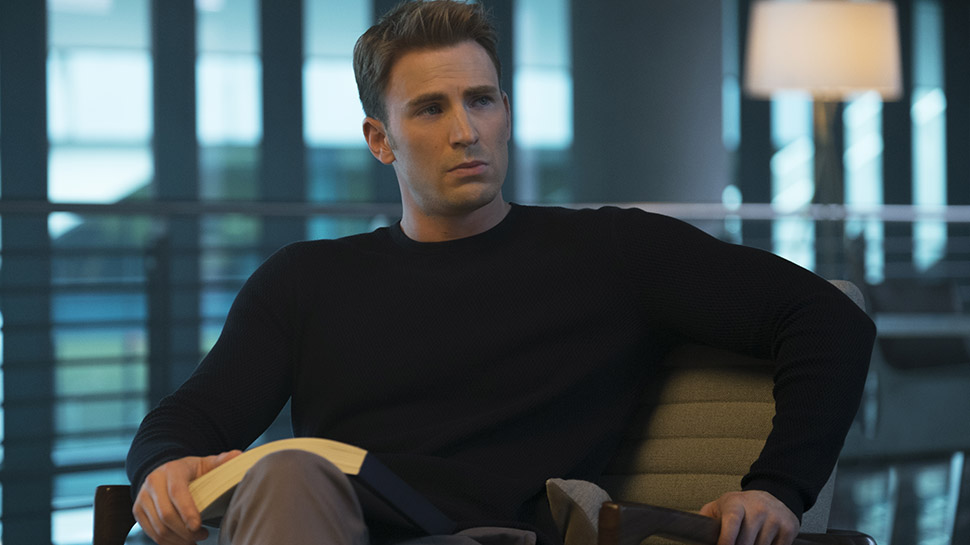 Chris Evans as Steve Rogers sitting in a chair