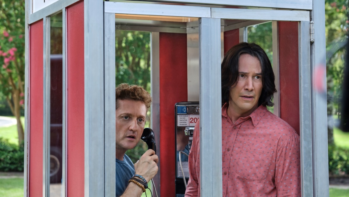 A worried Bill and Ted inside a phone booth