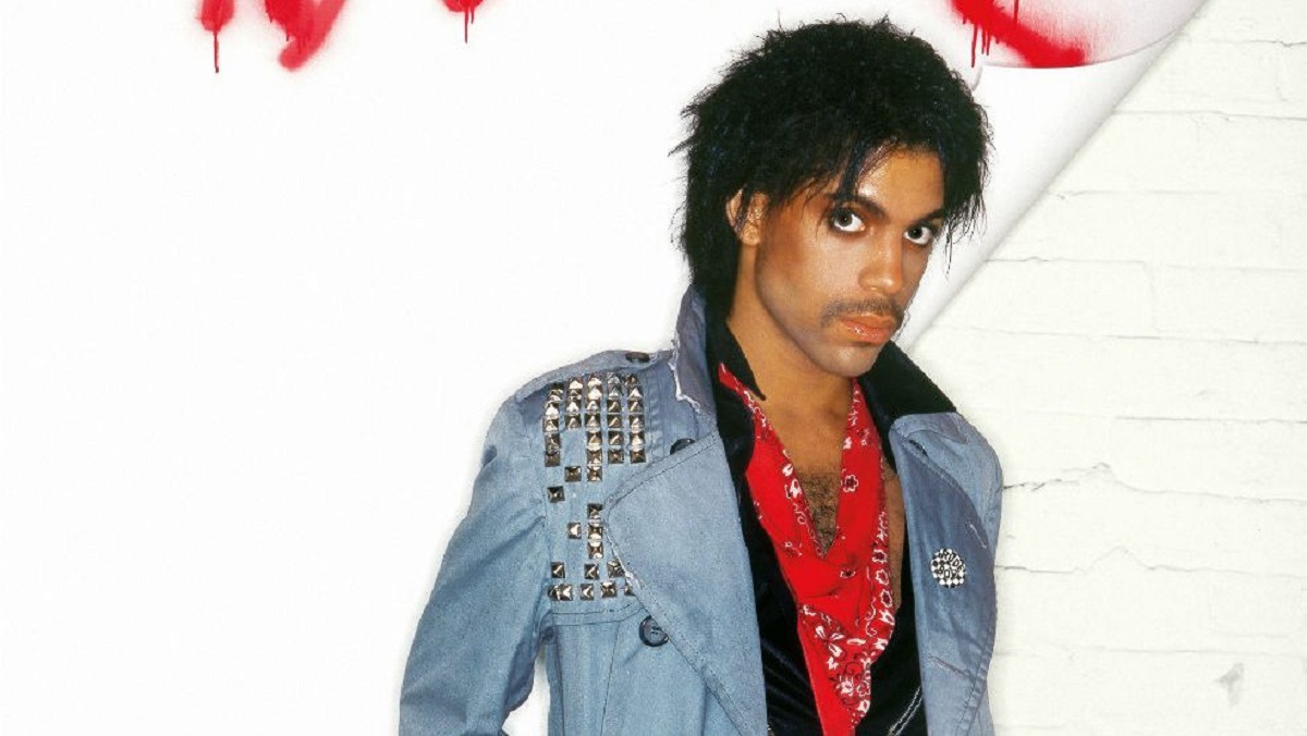 Prince album cover with the artist wearing a denim jacket and red shirt