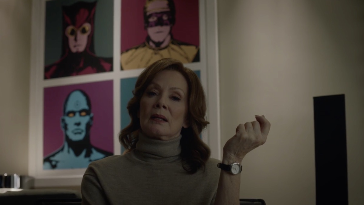 Laurie Blake in front of a poster of superheroes