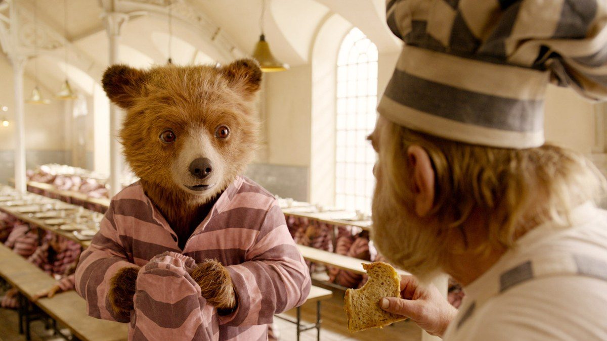 Paddington stares down a tough criminal in jail.