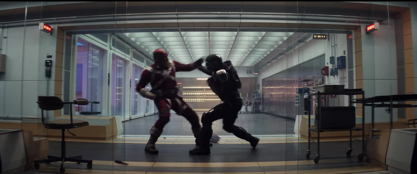 Two costumed agents fight in an office setting.