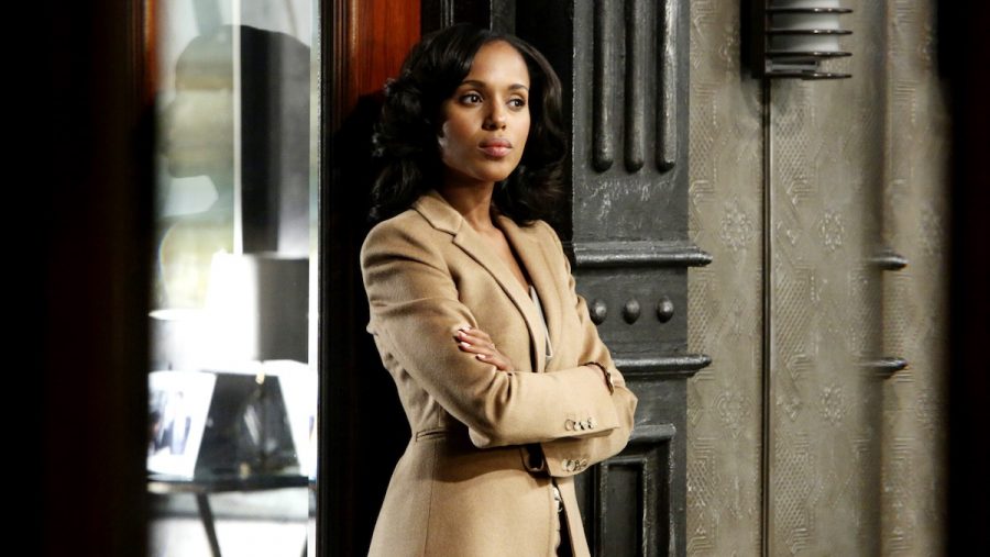 Kerry Washington wearing a suit and standing in a doorway on Scandal