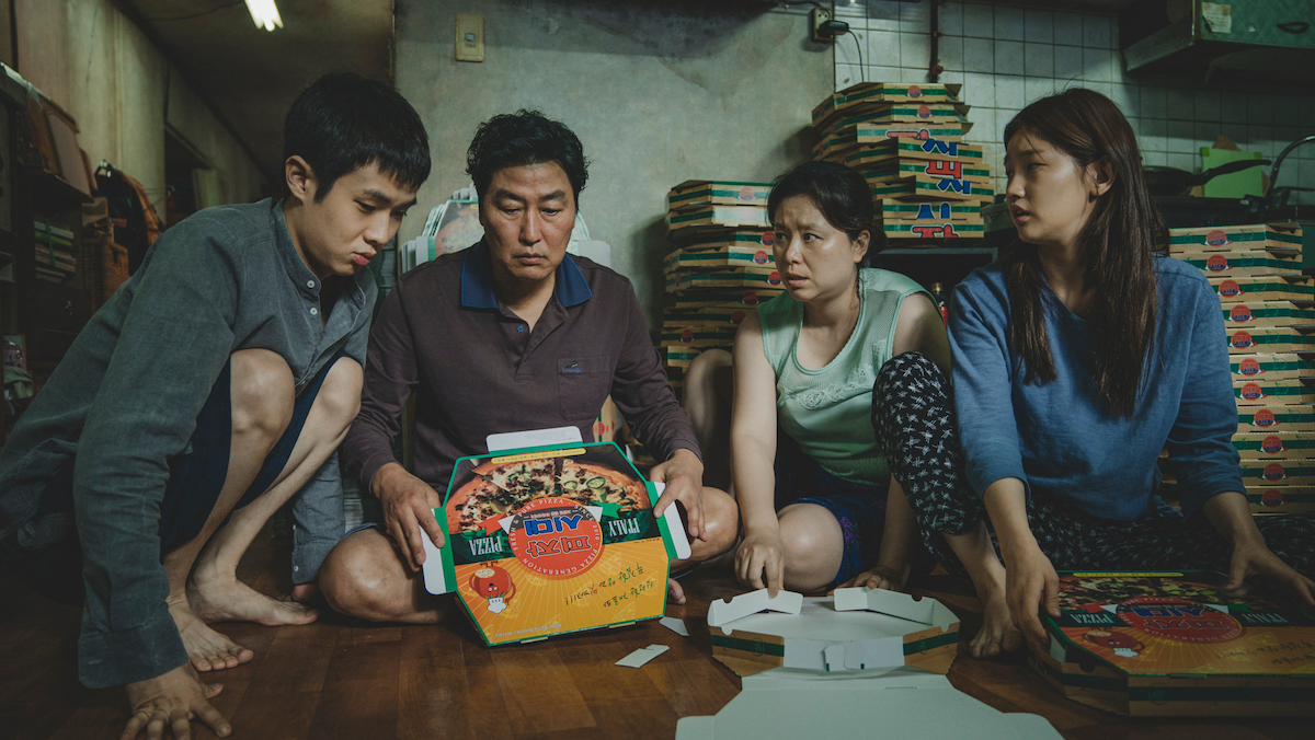 The Kim family folds pizza boxes for cash in their underground apartment in Parasite.