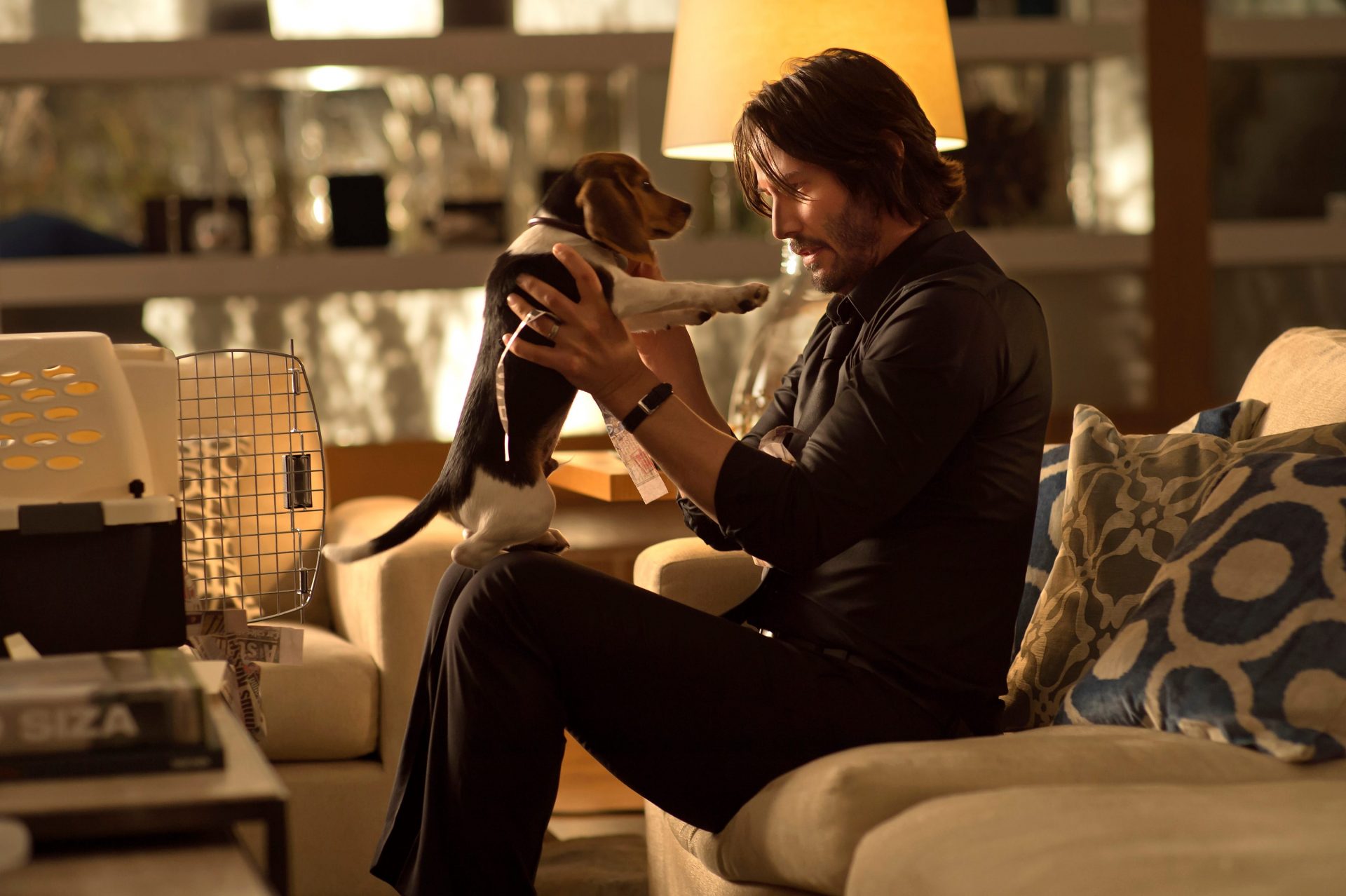 John Wick holding his adorable new puppy.