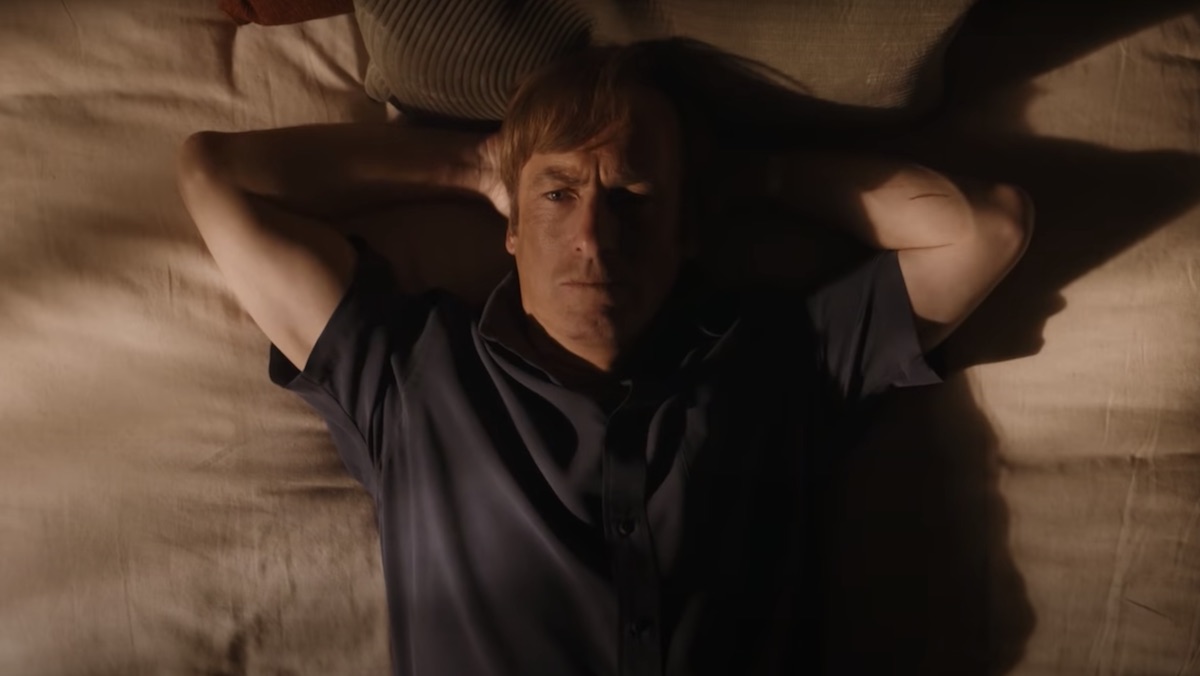 Bob Odenkirk's Jimmy McGill lies on his bed with his hands behind his head on Better Call Saul