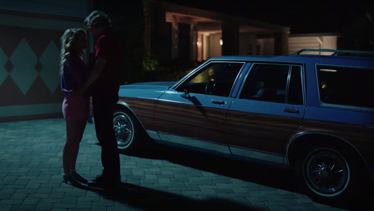 Jessica Rothe and Josh Whitehouse kiss in the driveway at night in the Valley Girl remake.