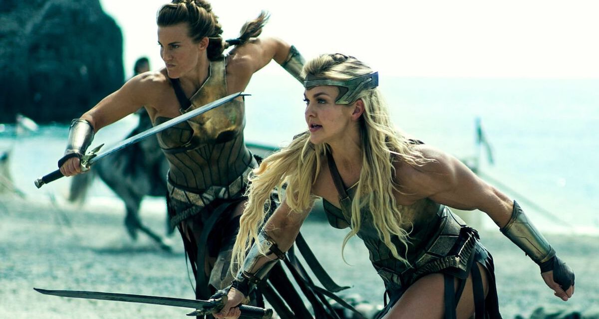 Amazons run into battle with swords.