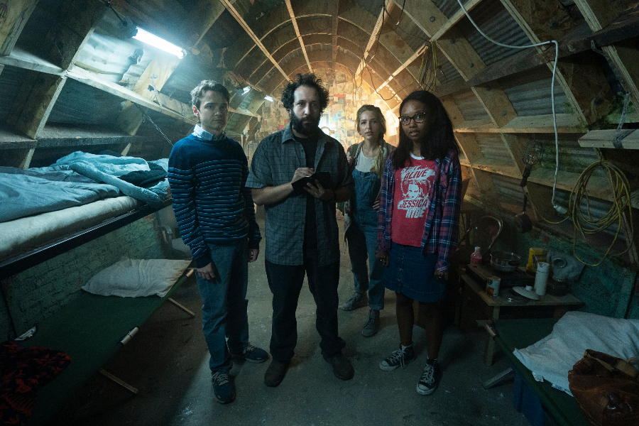 cast of utopia standing in a tunnel