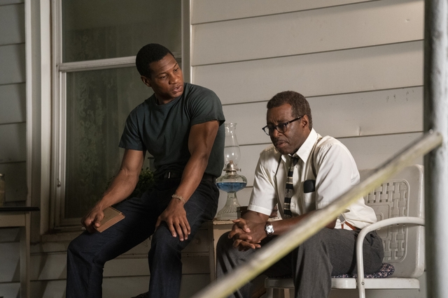 Jonathan Majors and Courtney B. Vance sit on porch in Lovecraft Country