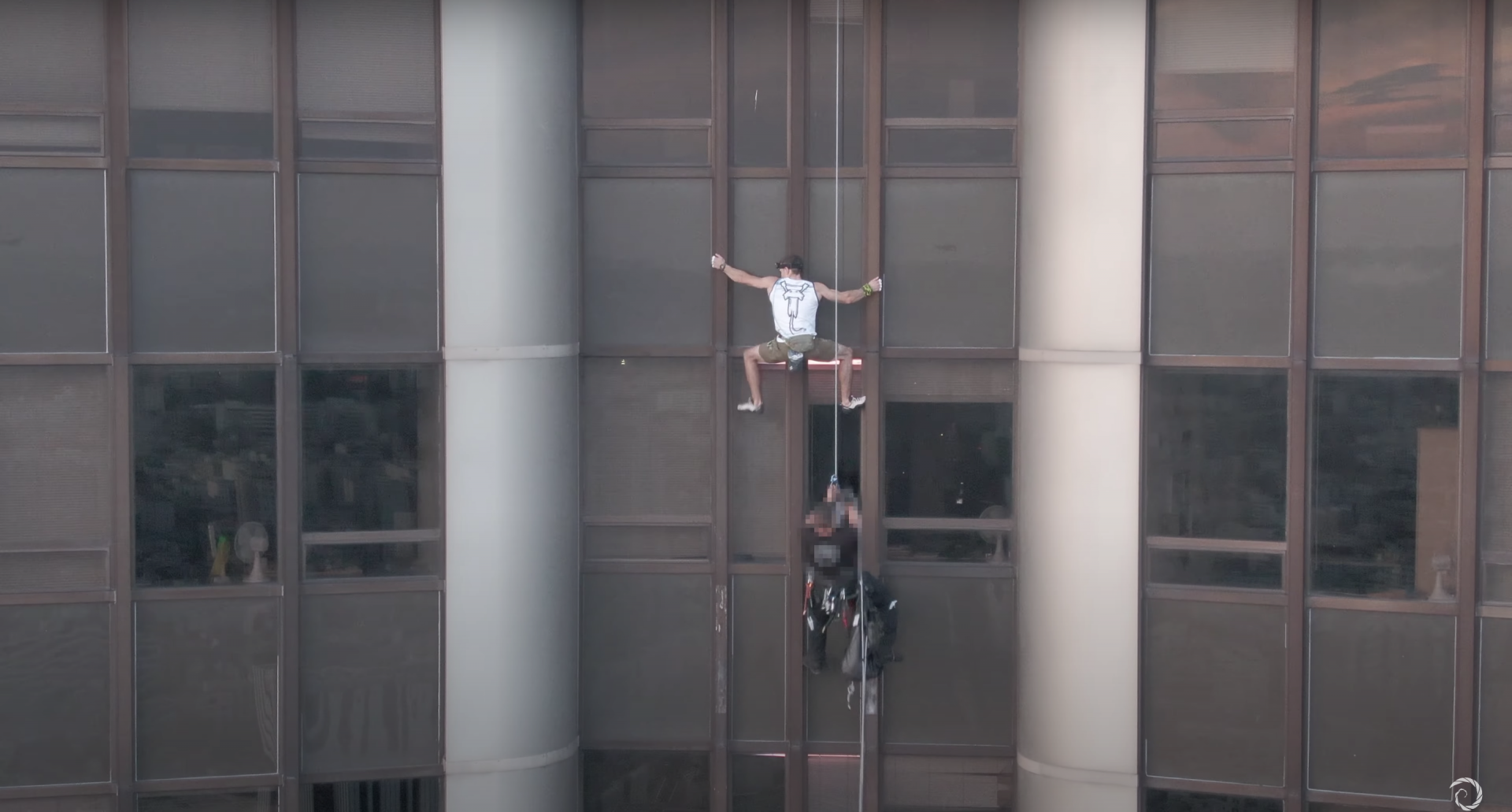 Climber scaling a skyscraper