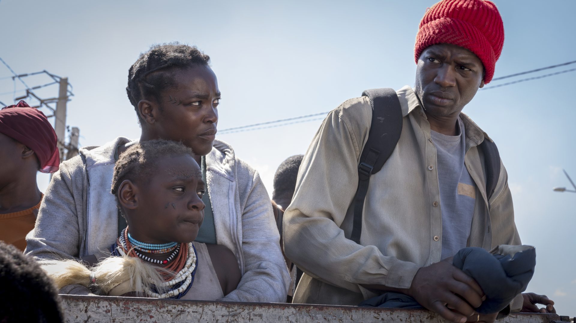 His House movie a couple and their daughter ride on the back of a truck 