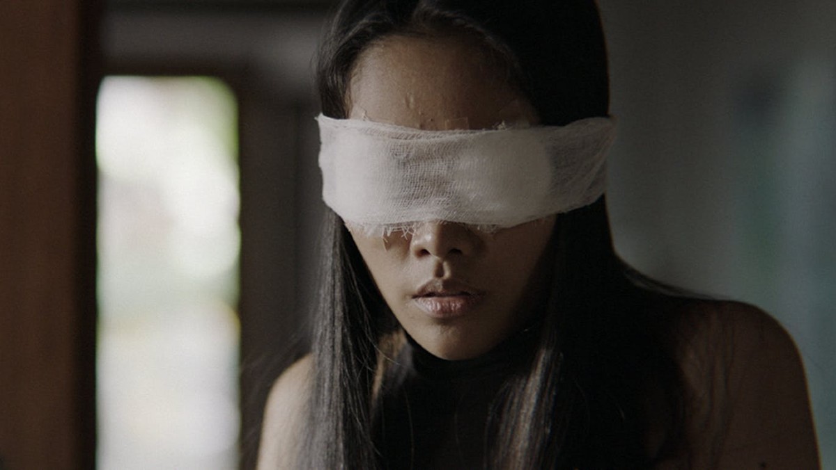 A woman is blindfolded in a still from Dearest Sister.