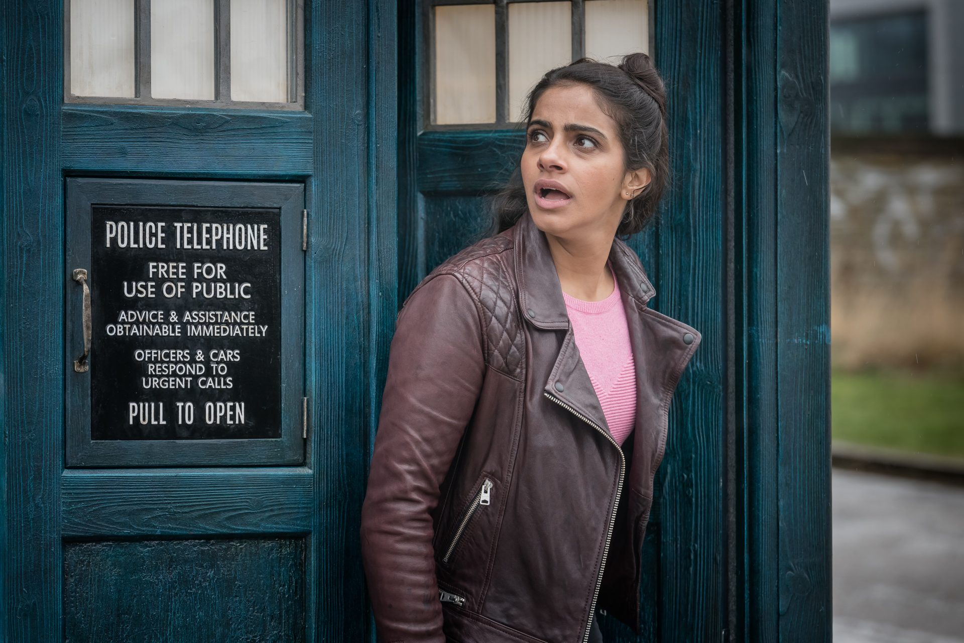 Yaz stepping outside of blue police box TARDIS