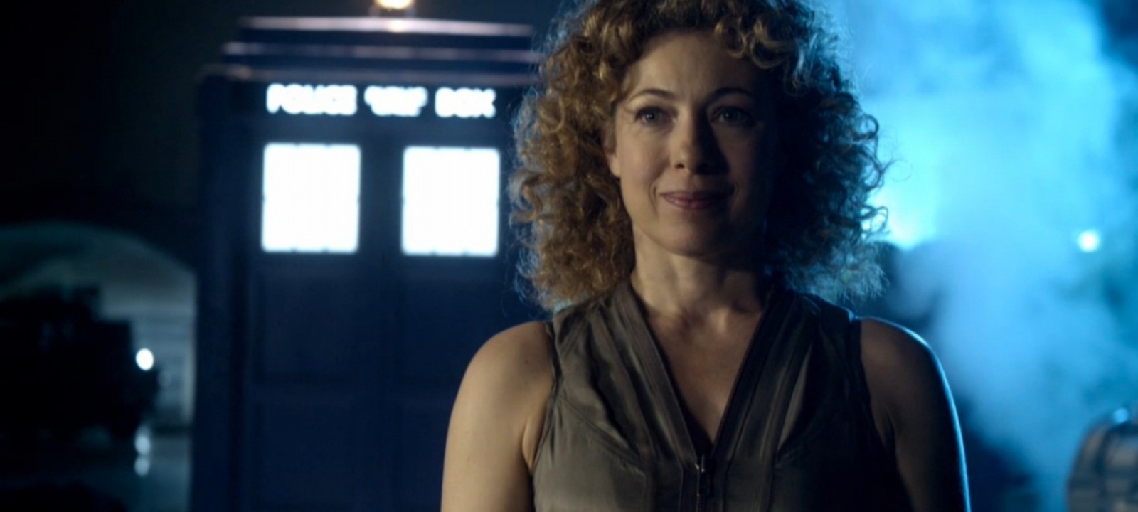 River Song Doctor Who stands in front of blue police box TARDIS