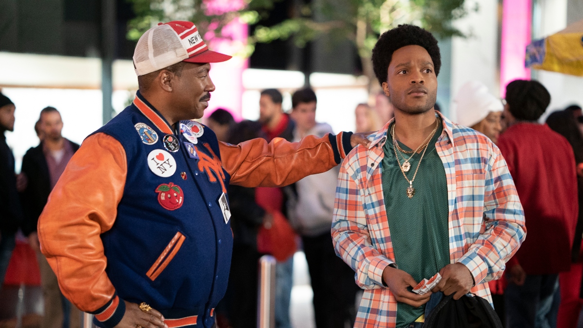 Coming 2 America stars Jermaine Fowler and Eddie Murphy stand together on set