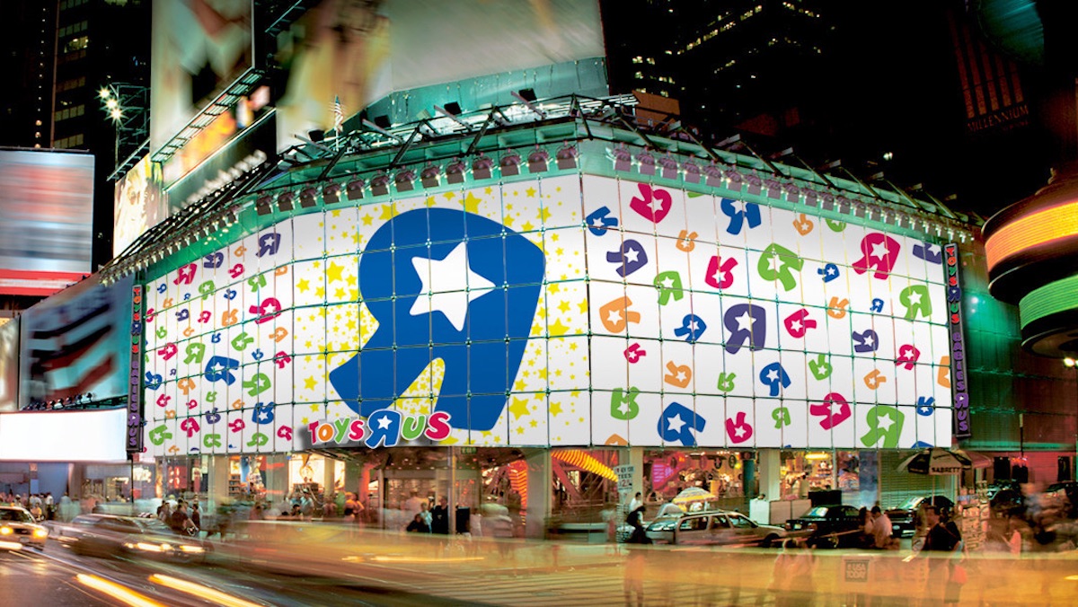 The old storefront from the Times Square Toys R Us location, seen lit up at night