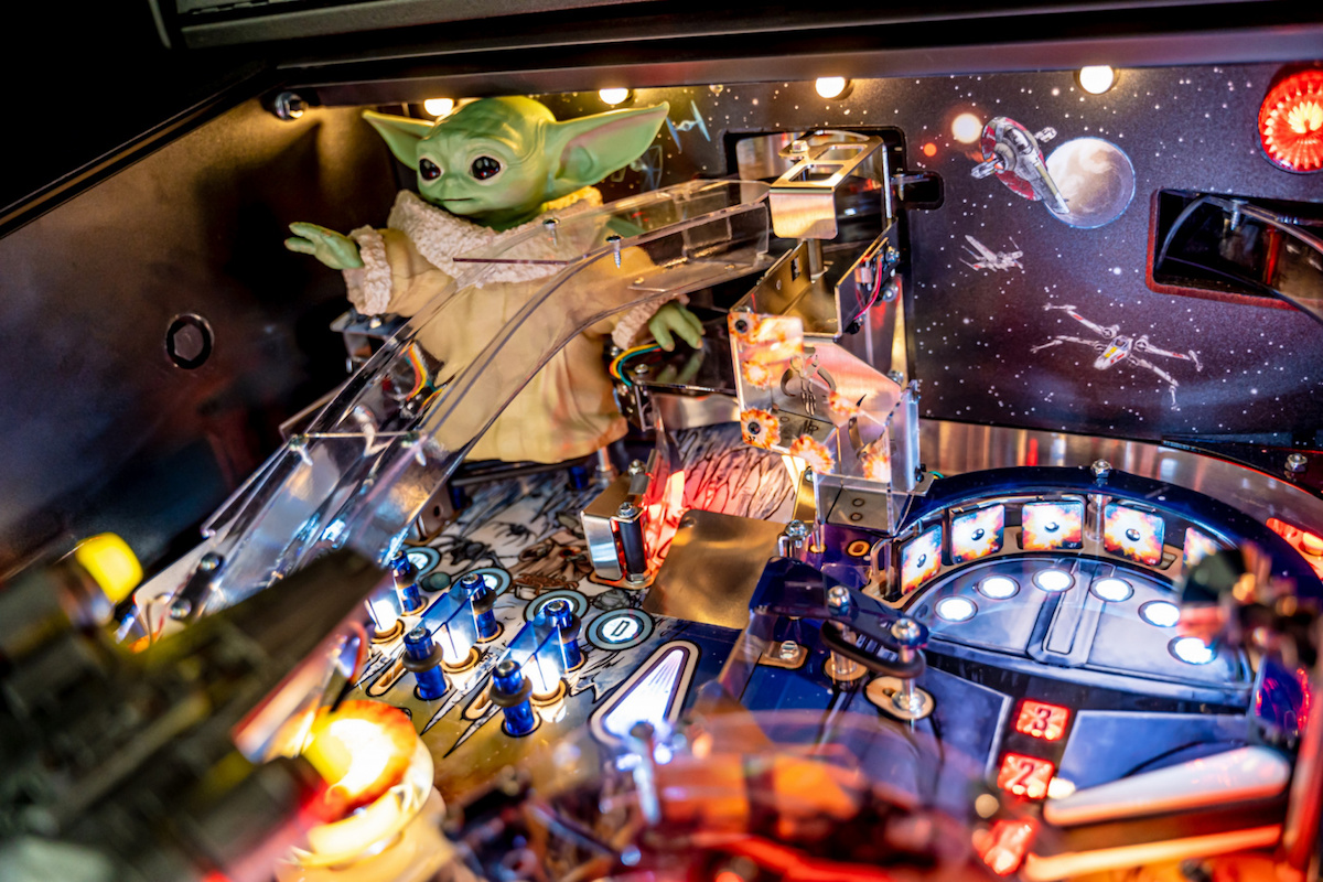 The inside of The Mandalorian pinball machine, featuring a Grogu statue in the top left