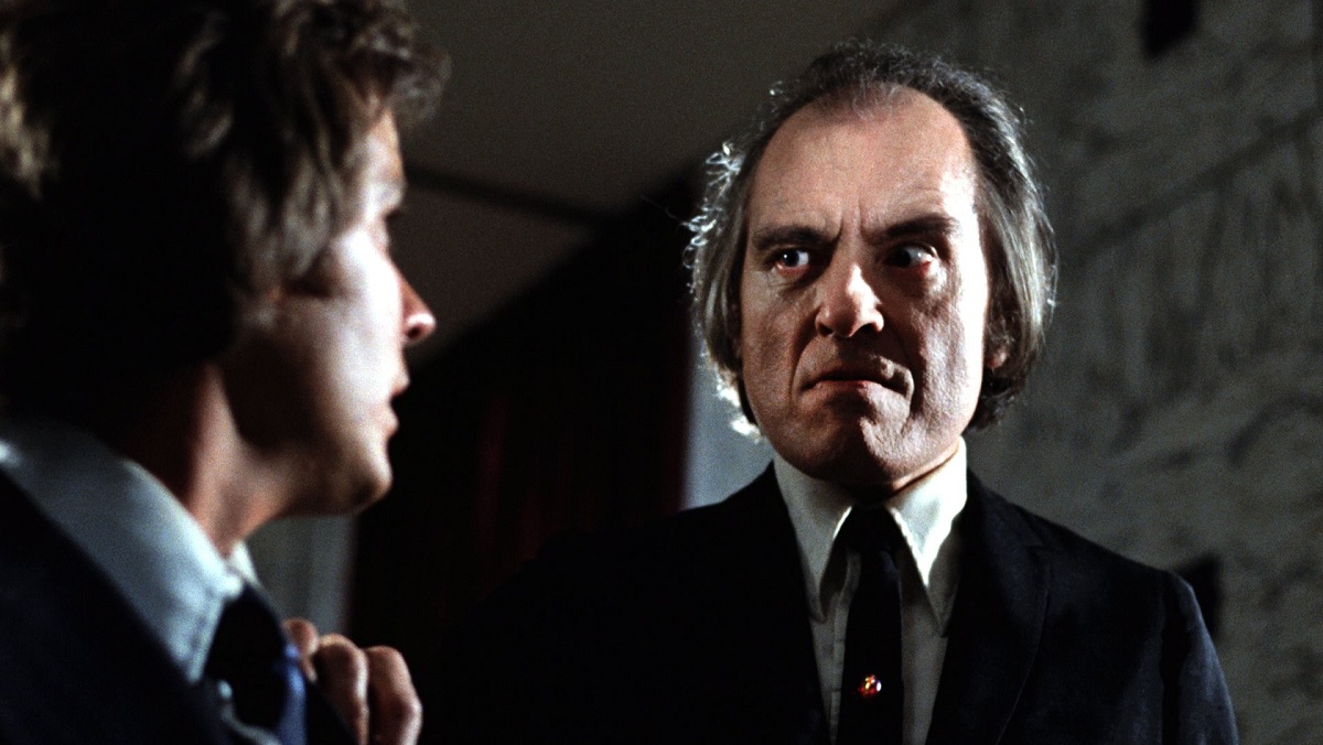 The Tall Man (Angus Scrimm) with his trademark arched eyebrow and scowling face, clamps his hand on the shoulder of Jody in 1979's Phantasm.