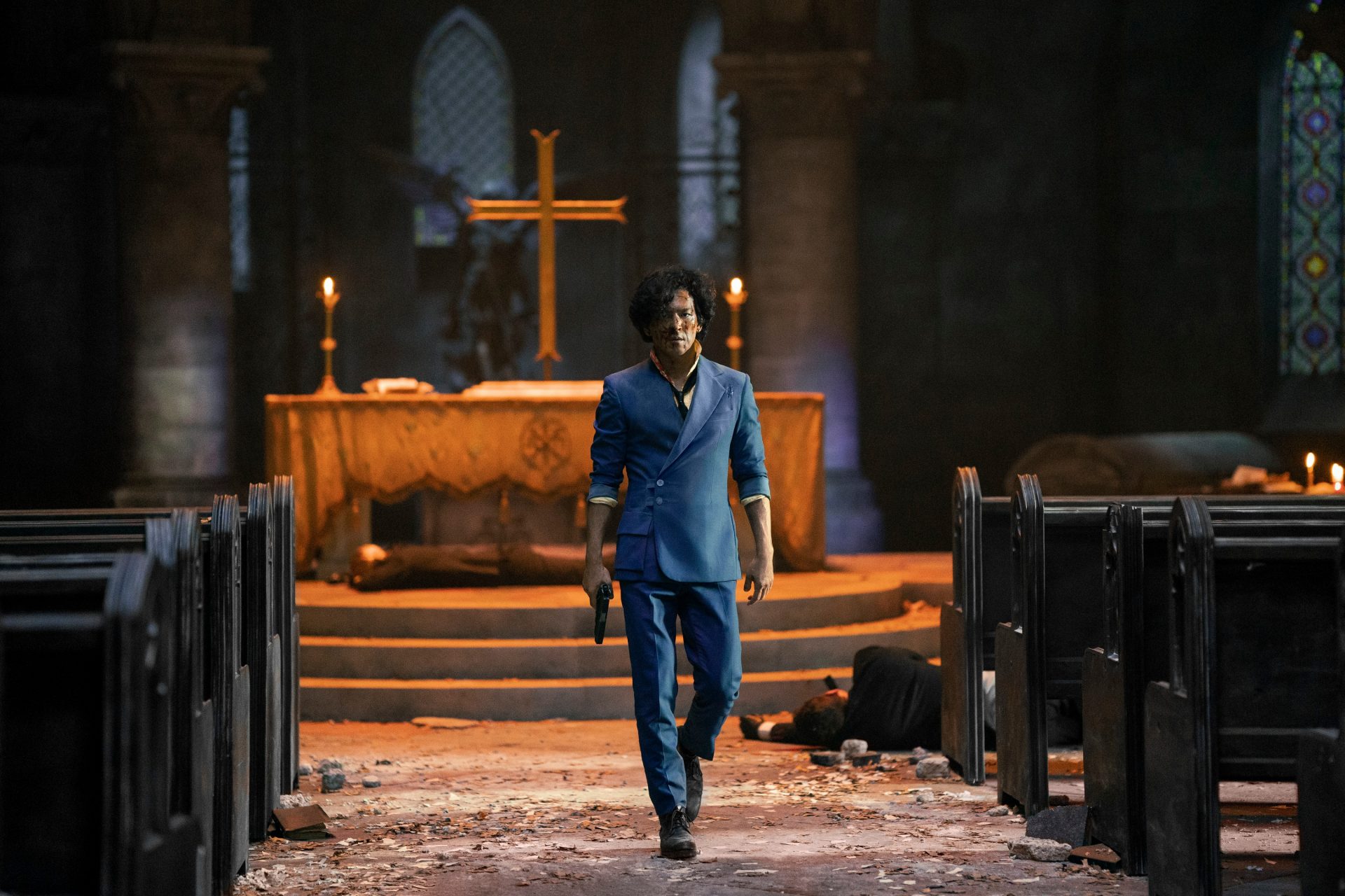 John Cho's Spike walking down a church aisle with a gun 