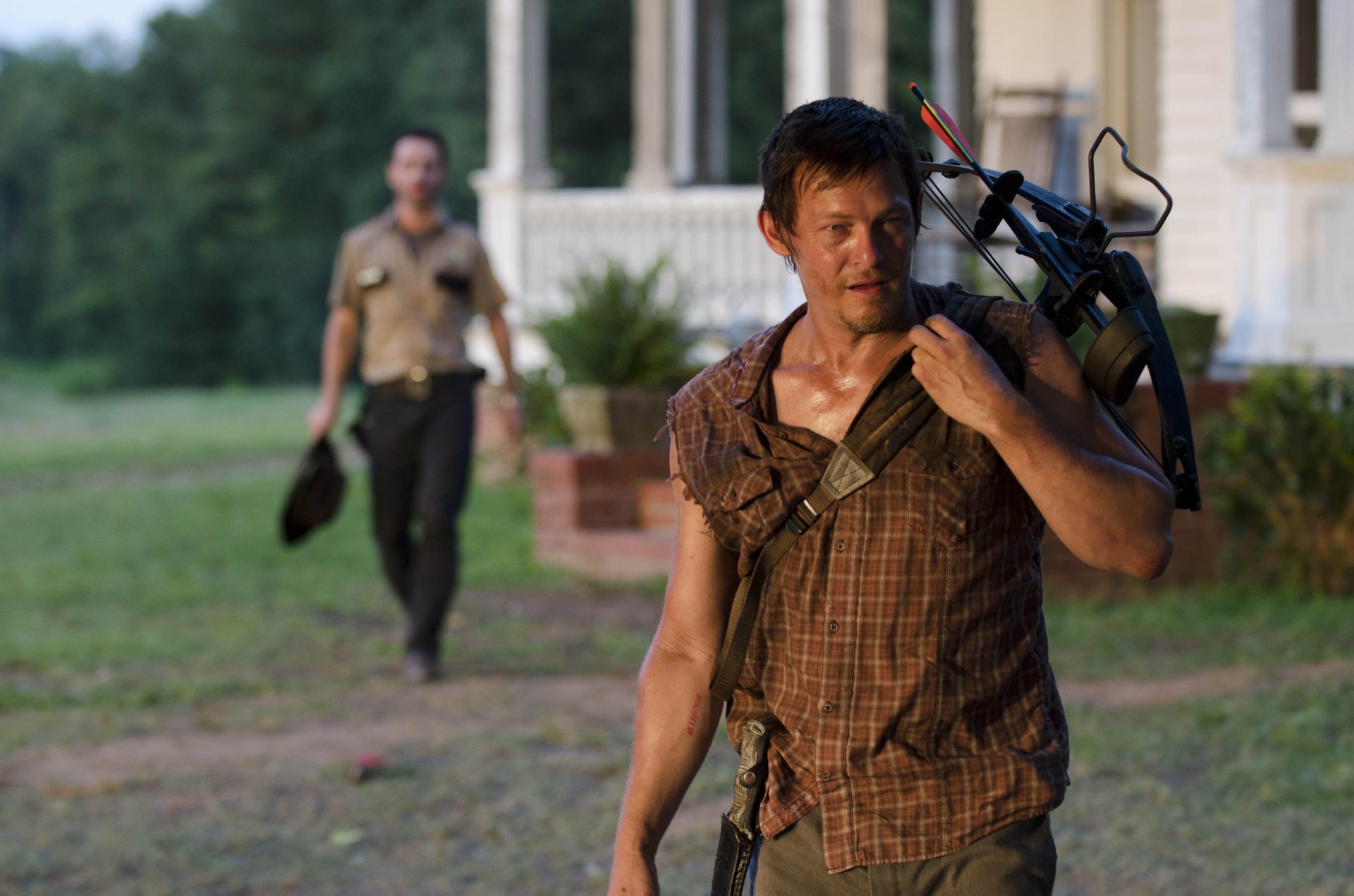 photo of Daryl DIxon from The Walking Dead season 2 with Rick Grimes in background