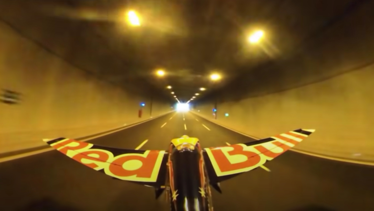 A single-prop plane with Red Bull written on its wings, flying through a tunnel in Turkey.