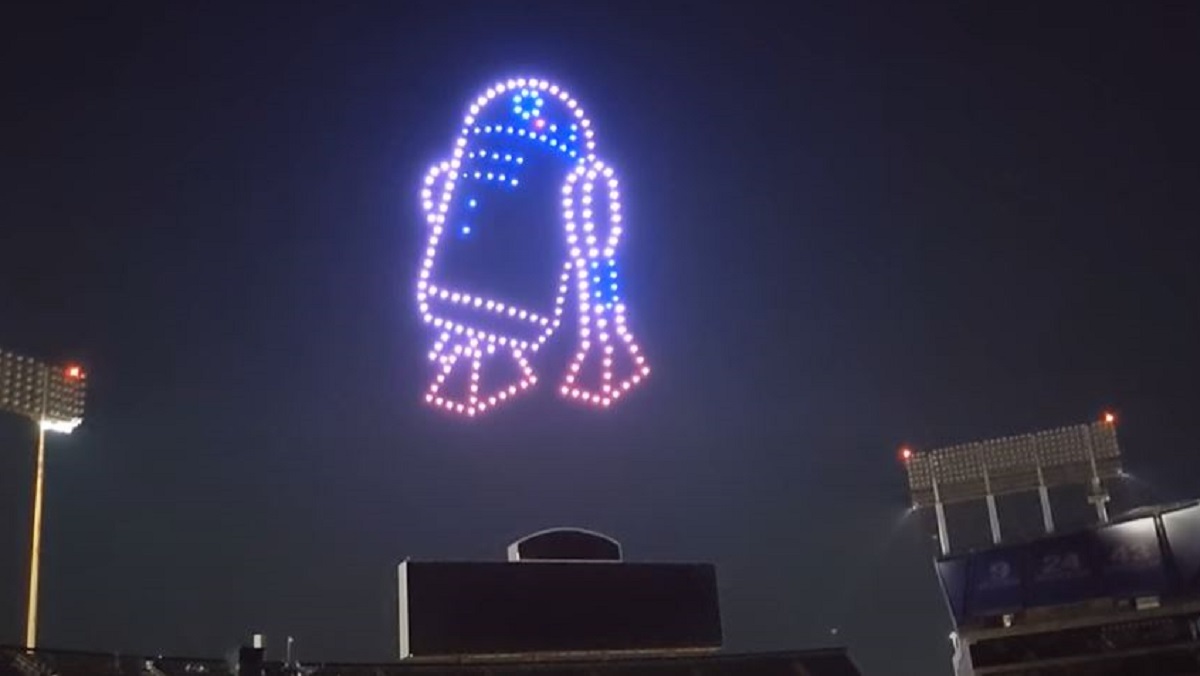 A drone show R2-D2 appears over a baseball stadium. 