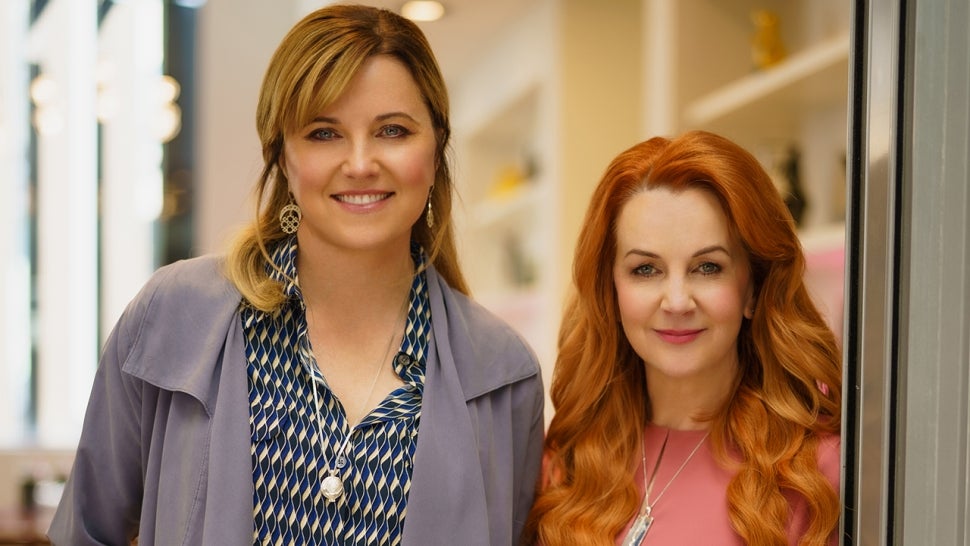 A promo shot from My Life is Murder shows Lucy Lawless and Renee O'Connor standing next to each other in a doorway