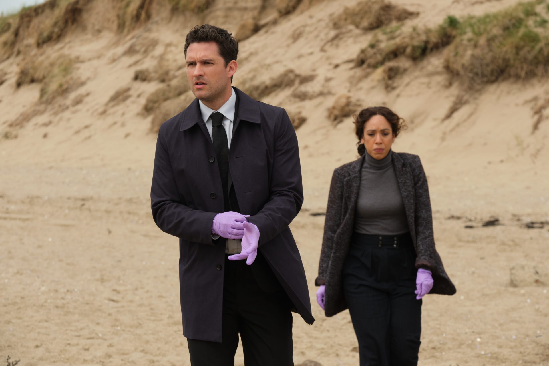 Ben Aldridge and Pearl Mackie walk on a beach in The Long Call