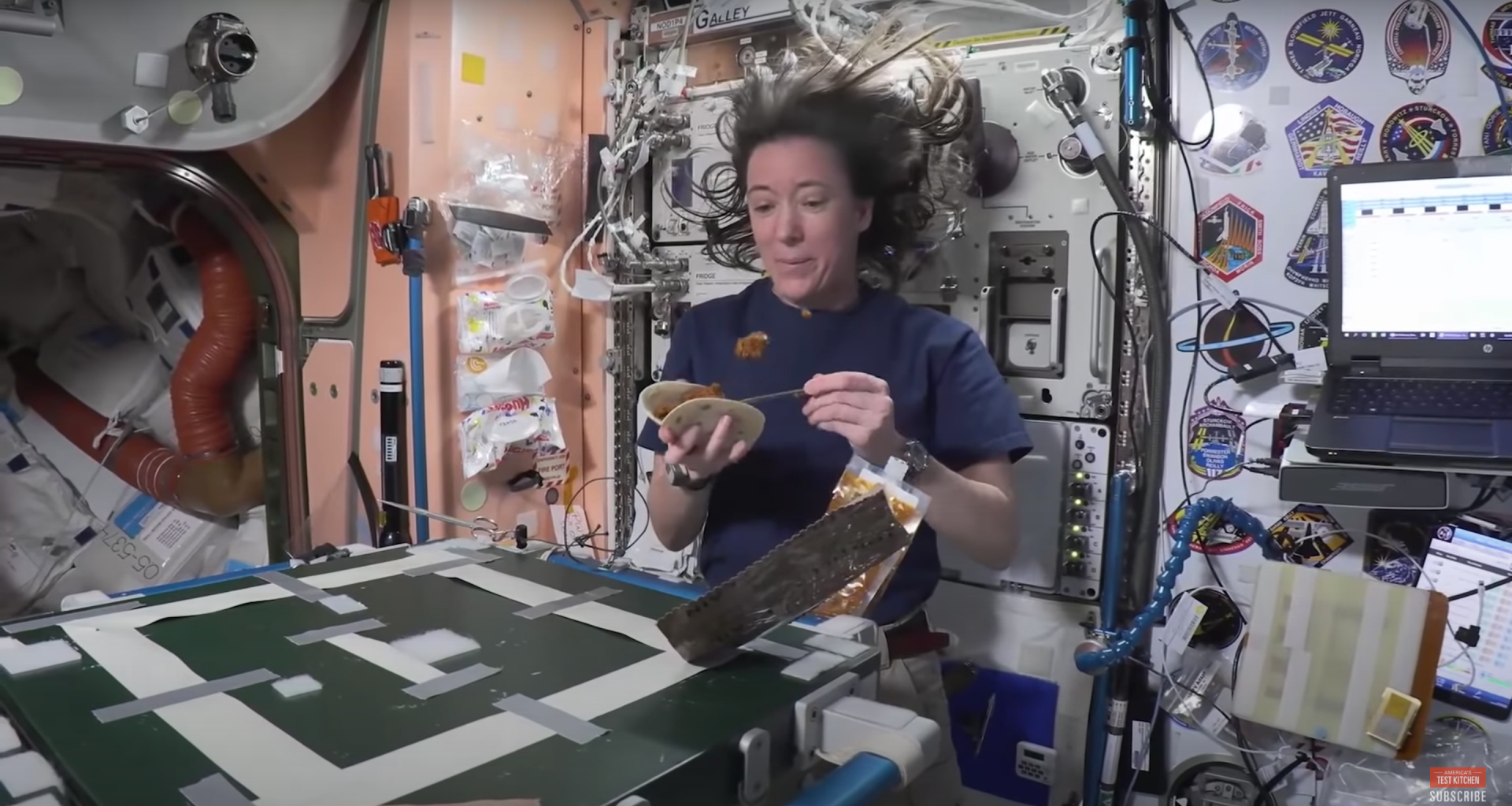 An astronaut preparing a fajita aboard the International Space Station as she shows how astronauts "cook" in space.