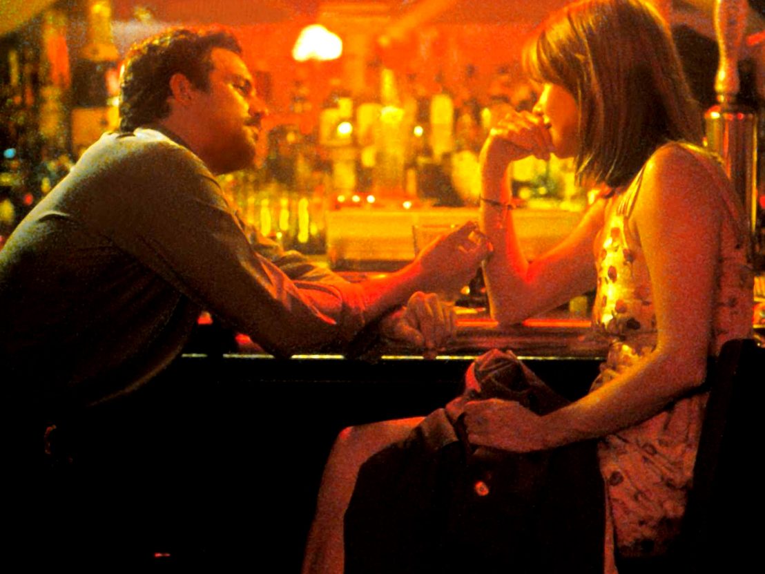 A still from In the Cut shows Mark Ruffalo and Meg Ryan sitting at a dimly lit bar