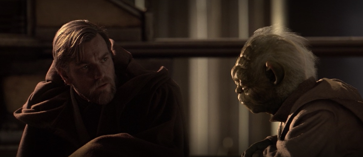 Obi-Wan Kenobi kneels down to speak with Yoda as they look at dead bodies in the jedi Temple in Revenge of the Sith