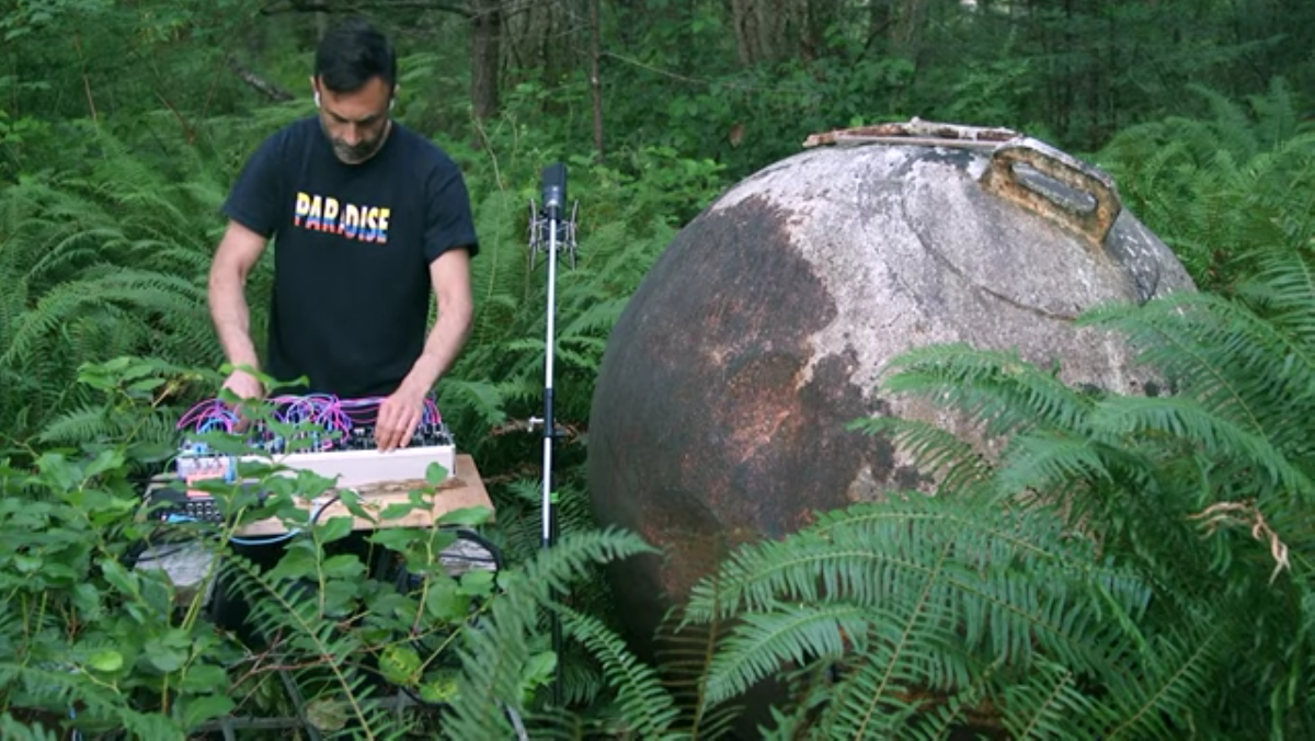 Artist Tarun Nayar with a synthesizer in the forest