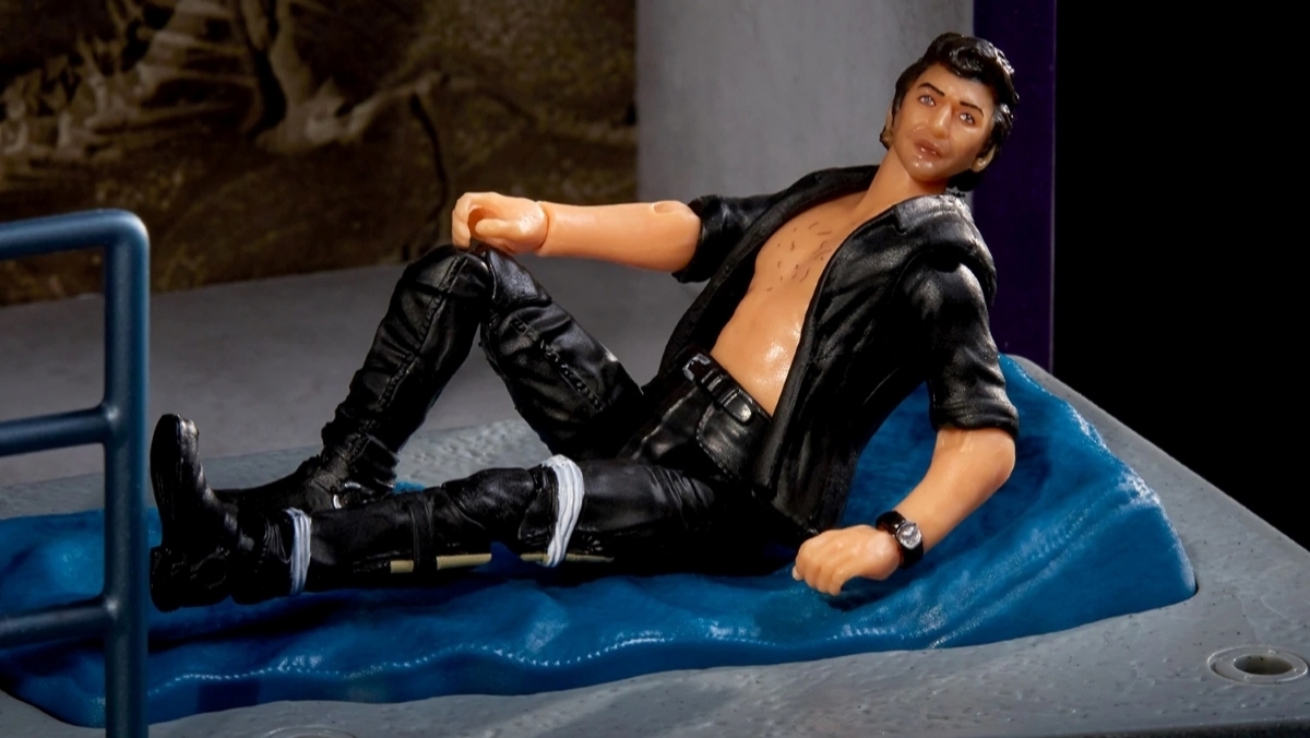 Action figure Ian Malcolm reclines with his black shirt open in a scene from Jurassic Park