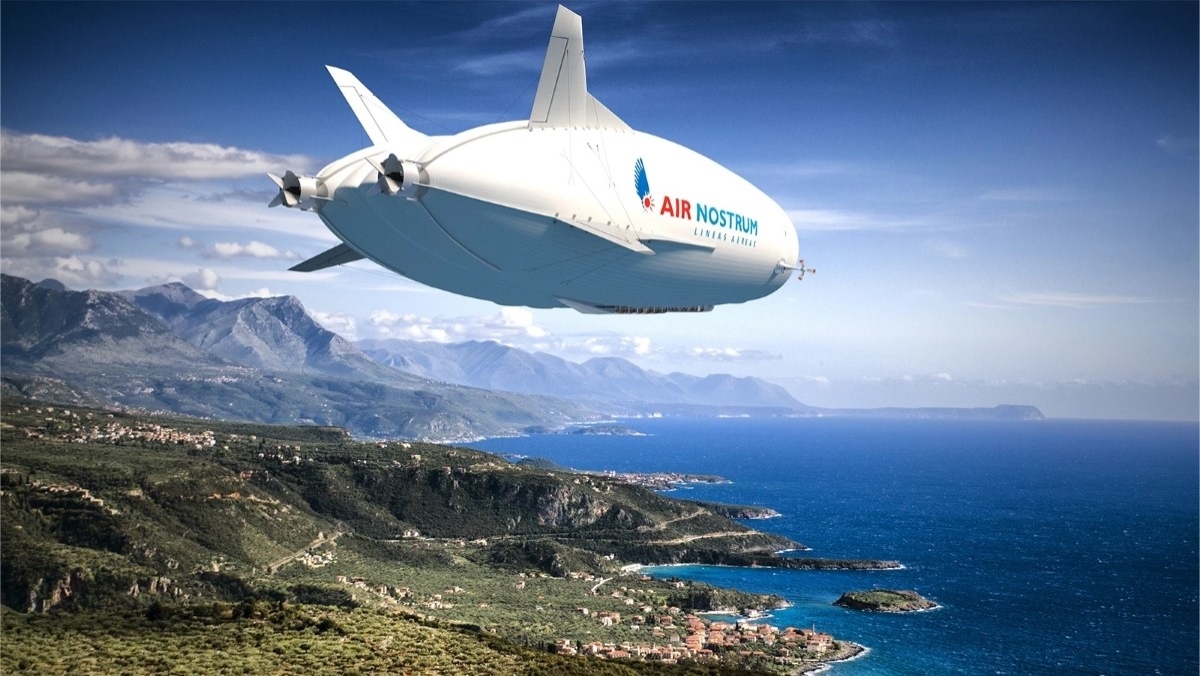 White air vehicle with Air Nostrum flying over a coastline