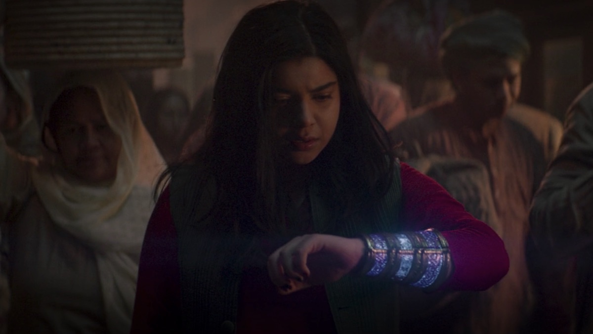 Kamala Khan looks at her glowing bangle on Ms. Marvel