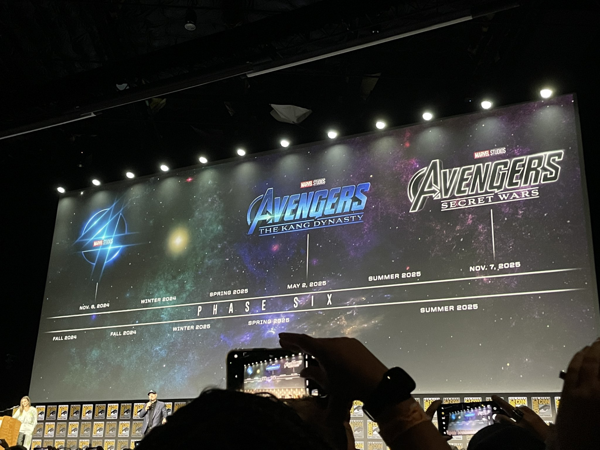 A still from Marvels Hall H panel shows a schedule for Phase Six shows Fantastic Four, Avengers: The Kang Dynasty, and Avengers: Secret Wars