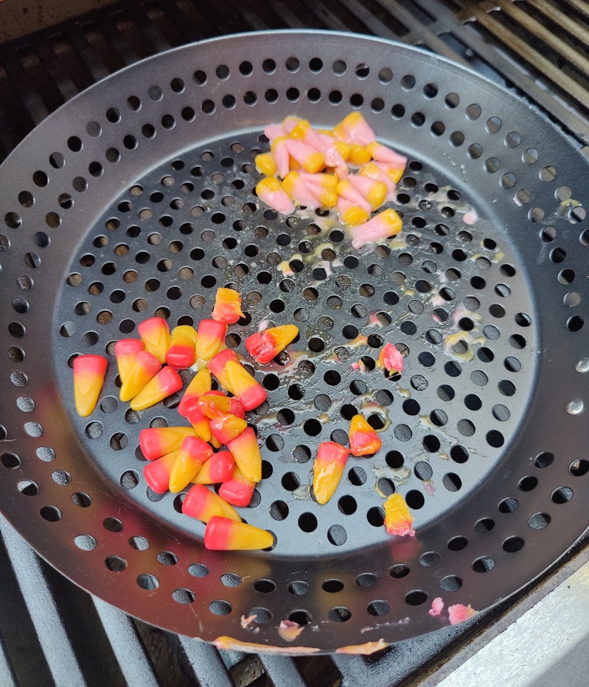 Tailgate candy corn melting in a grill pan on a grill