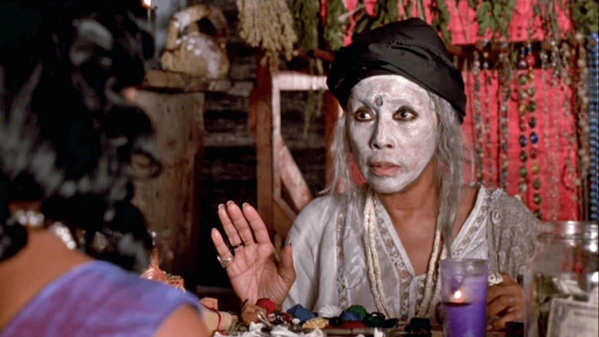 Diahann Carroll wearing white makeup and a bowler hat as a Voodoo priestess in Eve's Bayou.