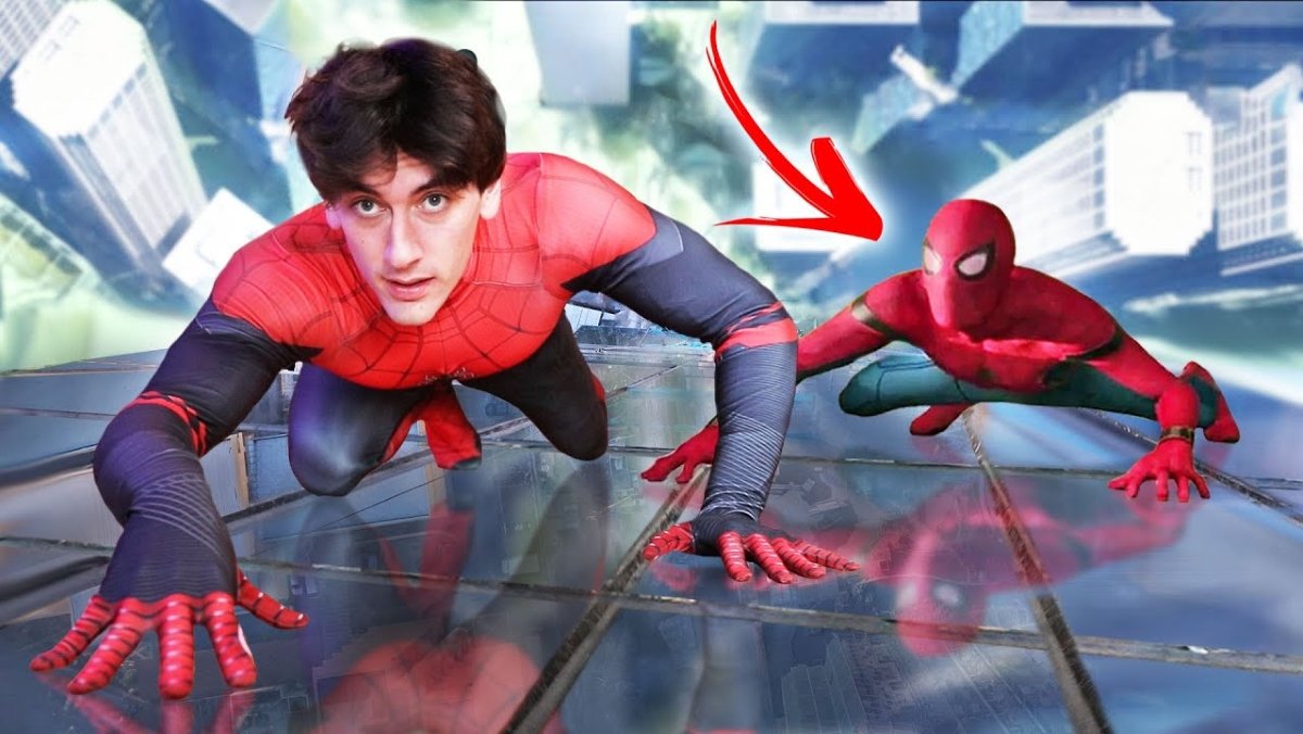 Jake Laser poses as if climbing a skyscraper dressed as Spider-Man