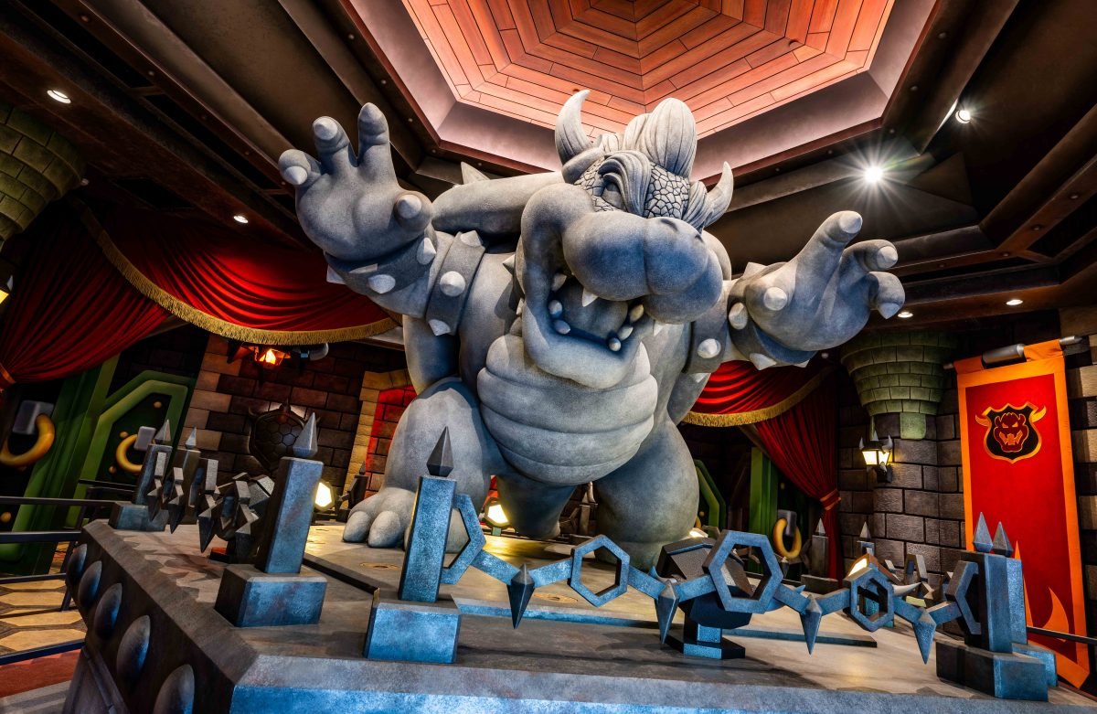 A statue of Bowser himself, inside his castle, the ride queue for the Mario Kart AR ride in Super Nintendo World Hollywood, also coming to Orlando