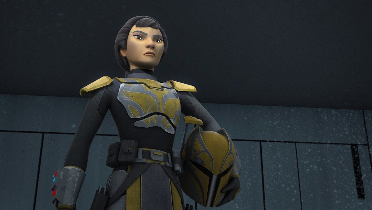 Ursa Wren seen from below in her Mandalorian armor with her helmet under her arm