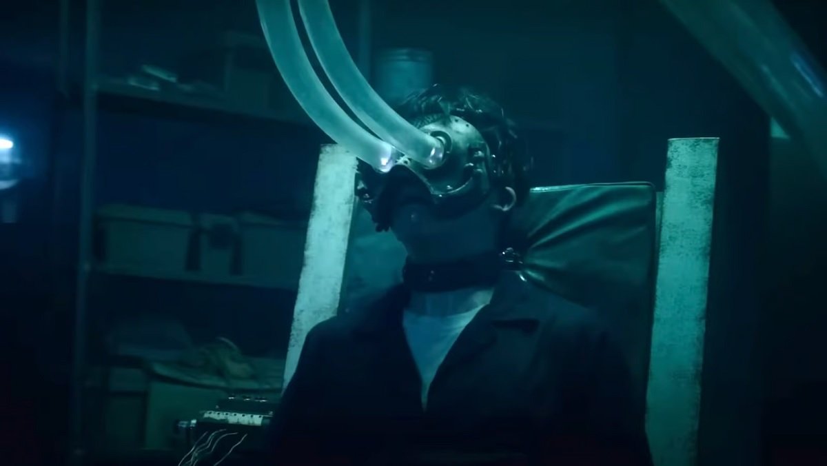 A guy has tubes attached to his eyes in Saw X