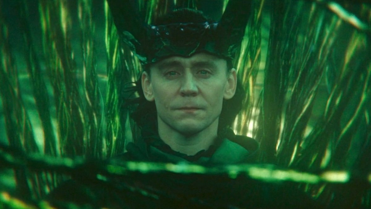 King Loki sits with the green strands of timelines, one of the best TV and movie moments of 2023 according to Nerdist