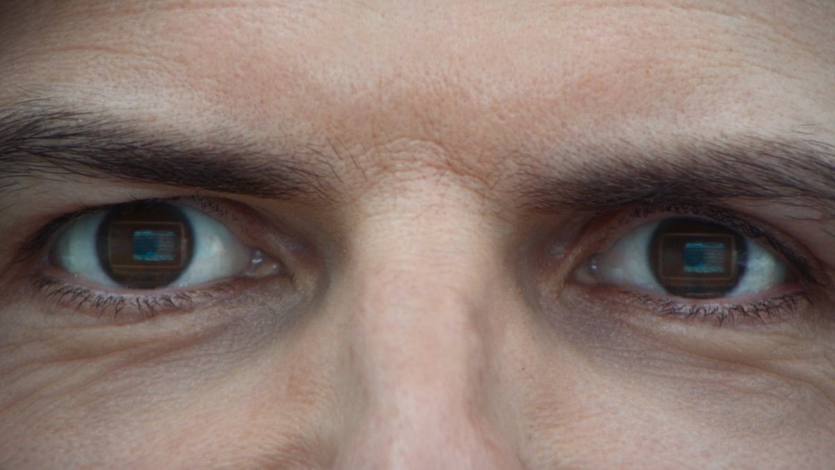 Closeup of Mark's eyes with his. computer screen reflected in his eyes on Severance