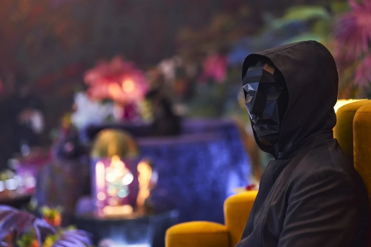A hooded man in a black mask on Squid Game