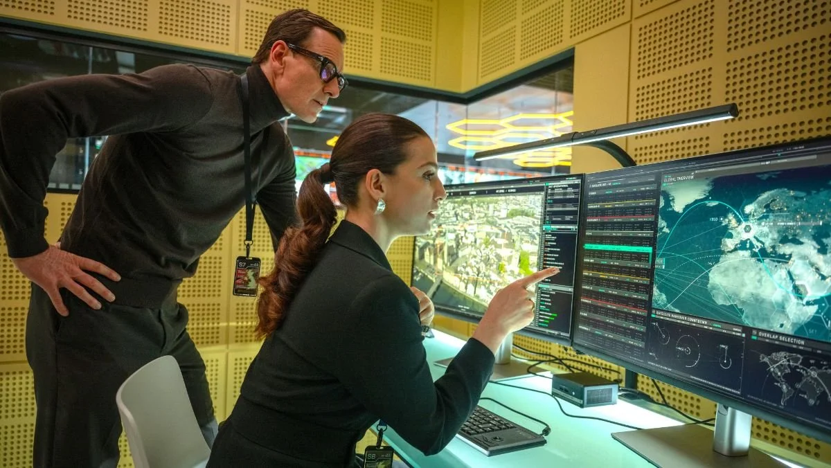 Black Bag - Michael Fassbender and Marisa Abela at a table with screens
