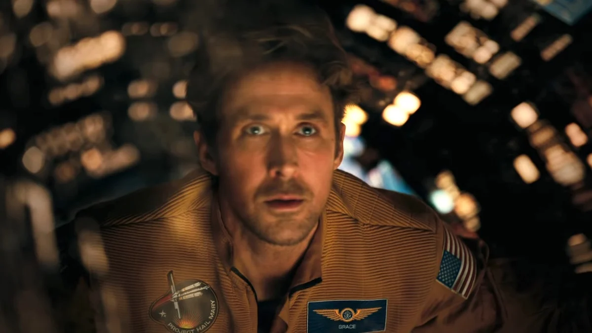 Ryan Gosling in an orange spacesuit floating in his ship on Project Hail Mary