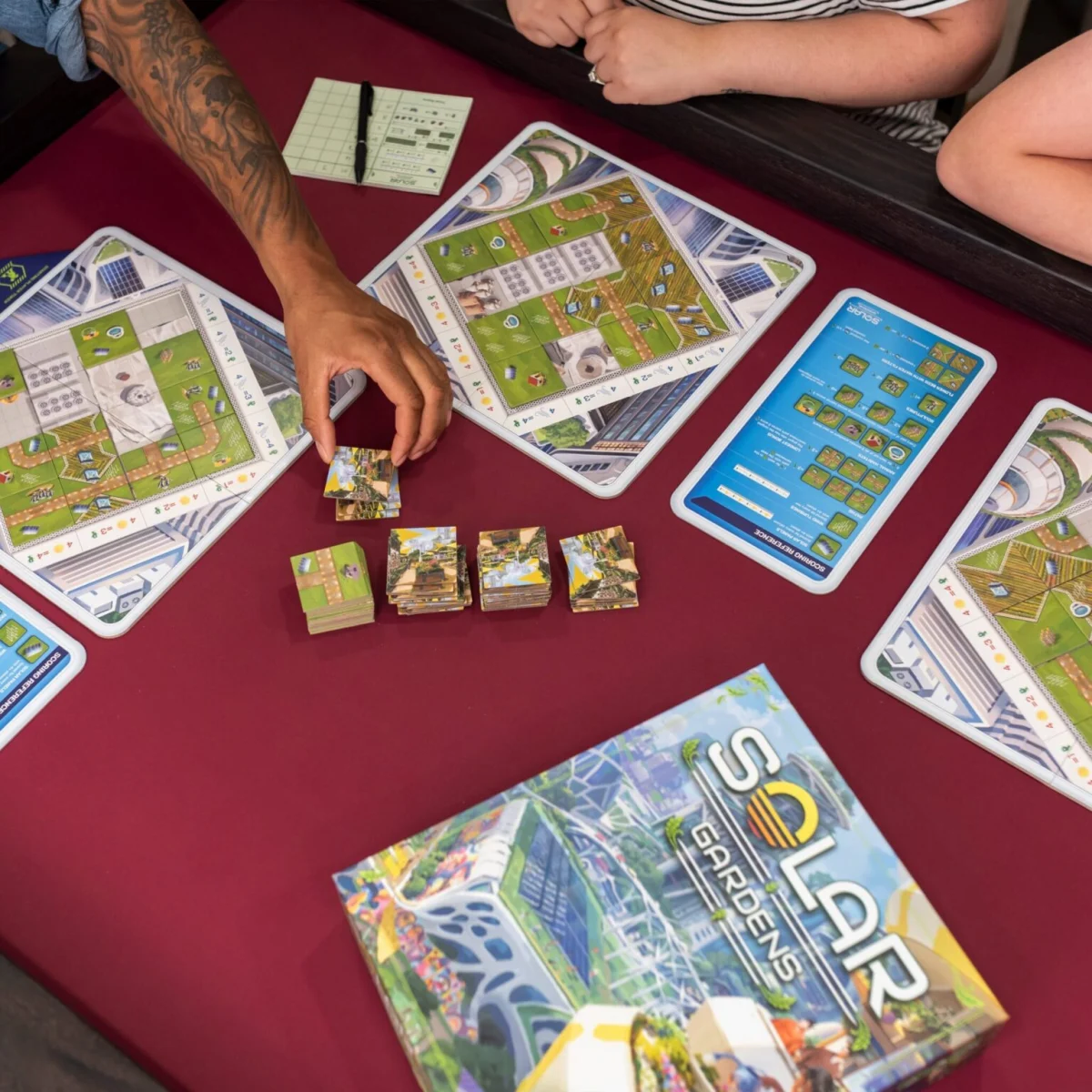 image of people playing solar gardens board game