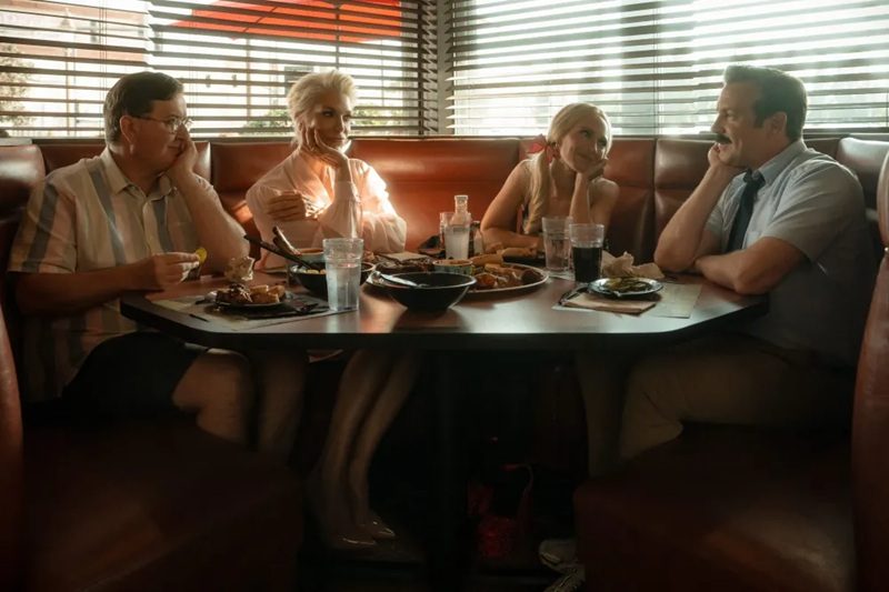L-R: Jeremy Swift, Hannah Waddingham, Juno Temple, and Jason Sudeikis sit in a booth at some American-ass restaurant in Ted Lasso season 4.